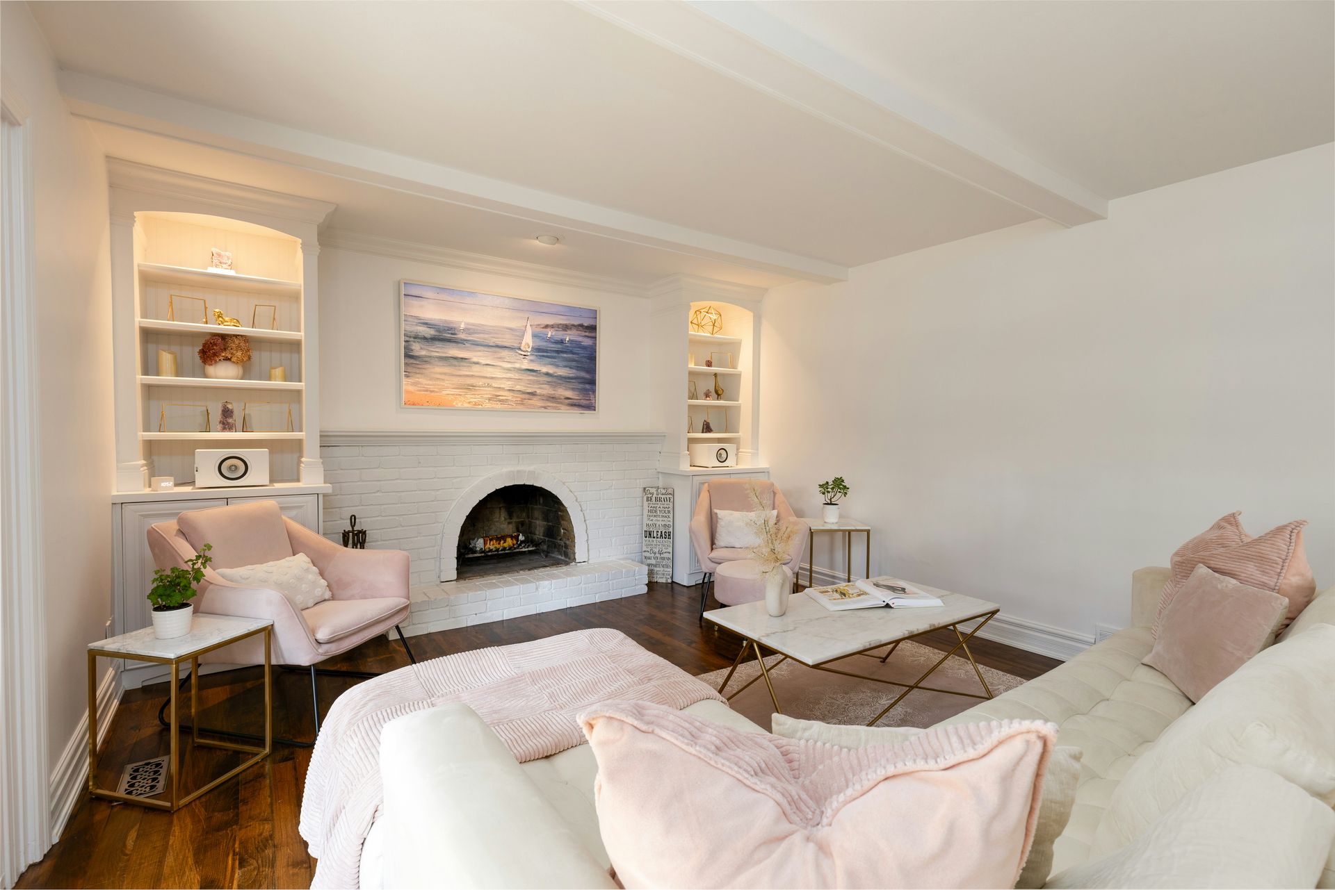 A cozy living room with white walls and fireplace